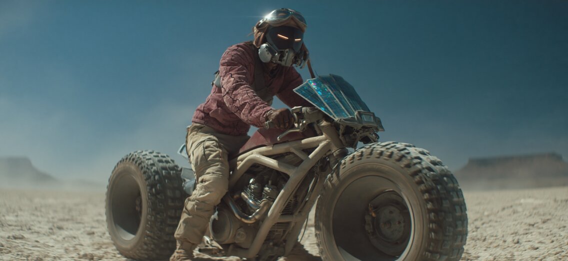 The Rider on his prototype motorcycle in the salt-flat desert — the Midjourney hero shot that started it all